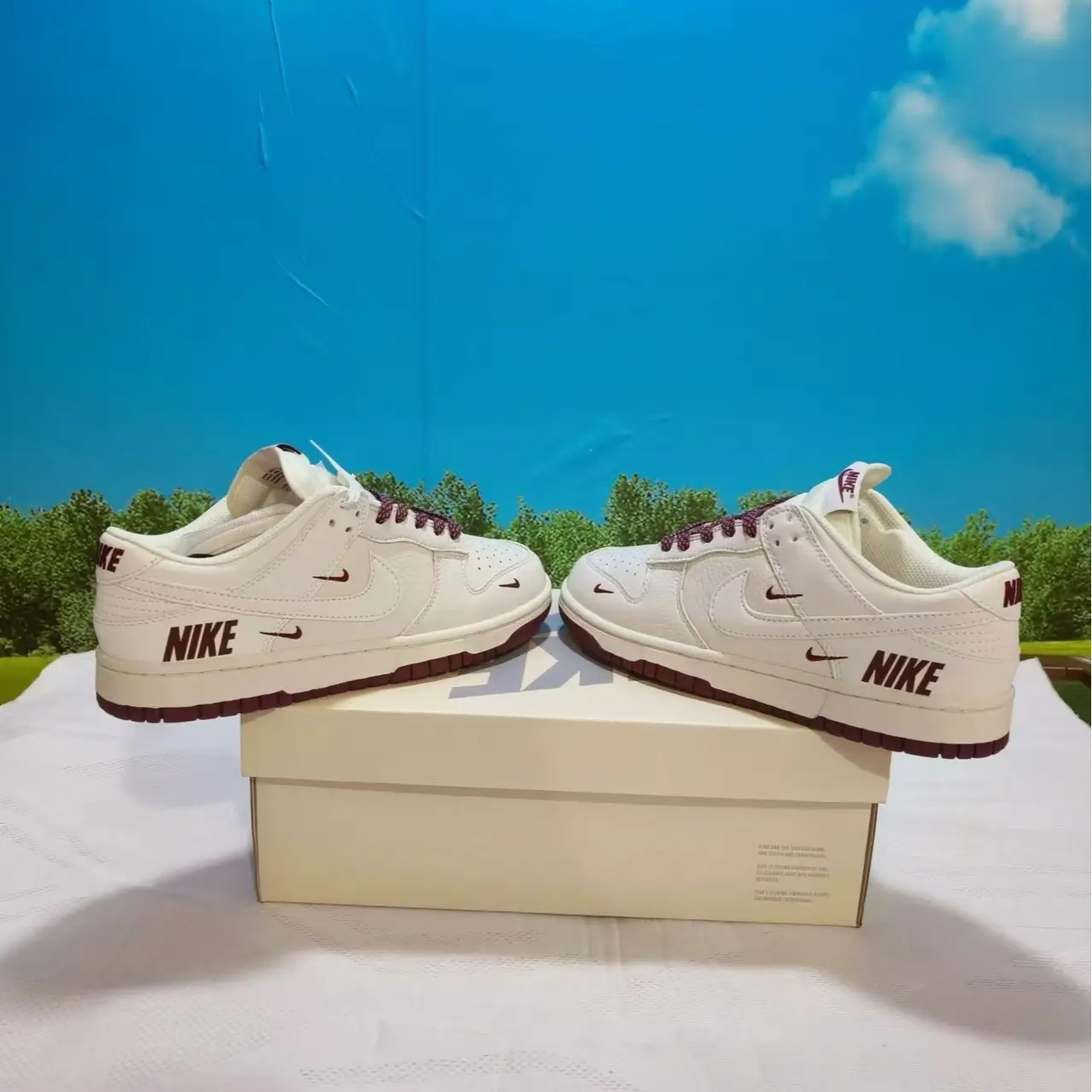 Retro low-top full-grain leather casual sneakers with cushioned foam insoles offering all-day lightweight walking comfort, premium creamy off-white smooth leather decorated with multi mini burgundy logo embossed details and woven burgundy laces