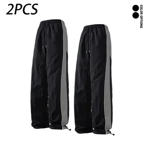 Spring/autumn men’s casual long pants featuring a design-forward color-block patchwork look; versatile for everyday wear, sports, and fitness; adjustable elastic cuffs.
