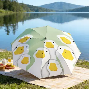 Portable folding umbrella The umbrella features a pattern of cartoon duck faces against a light green background. Suitable for daily travel use, holiday Gift