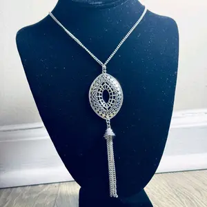 Elegant Silver Tone Oval Pendant Necklace with Tassel Detail for Women's Fashion Accessory