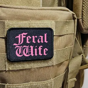 Feral wife meme 2"x3" morale patch with hook and loop backing pink on black