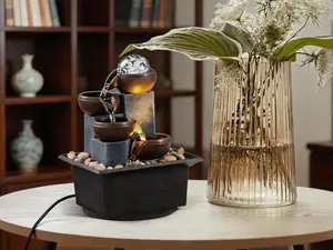 4-tier indoor tabletop waterfall fountain with natural river rocks, LED lighting and a bubble ball. Creates calming ambient sounds for relaxation at home or work, and serves as a delicate festival gift.