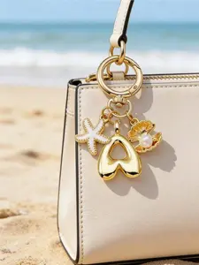 Golden A-Z Initial Letter Keychain Adorned with starfish and ocean pearl shell details, personalized charm for handbags and backpacks. Ideal gift for girls, teens and women on birthdays, Valentine’s Day, weddings and bridesmaid occasions.