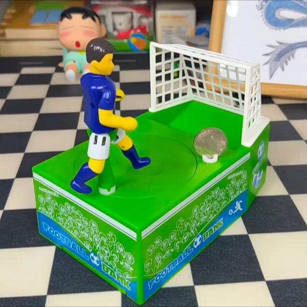 2026 Creative Kicking Soccer Piggy Bank, World Cup Coin Bank, Football-Themed Souvenir Gift, Desktop Decoration, Novel Cartoon Money Bank