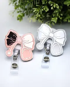 Bow with Stethoscope Badge Reel, Laser Engraved with Smooth Mirror Finish, Funny Badge reel for nurses, xray techs and hospital workers. Retractable swivel clip with a 360 rotation. Great gift for coworker. Cute Badge for Work. Badge clip, Badge pull