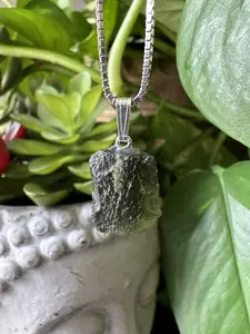 Authentic Moldavite Pendant with Necklace: A 1.9 grams genuine celestial gem, verified for authenticity. Embrace cosmic energies, deepen your spiritual connection, and leap to a transformation journey. Elevate your style and consciousness now.