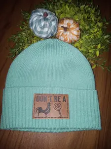 women's teal beanie with engraved leather patch