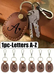 Leather keychain with artistic heart-shaped black letters A-Z, handcrafted portable leather keychain with key ring, full coverage protective case, suitable for 2021 AirTags