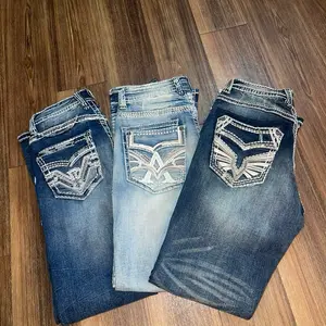 Rip and Washed Blue Jeans with Distressed Design and Unique Embroidery for a Trendy Look