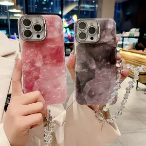 This new stylish phone case is compatible with iPhone 16/16 Pro Max/15 Pro/14 Pro Max/13 Pro. It features a shell-pattern design with a gradient pink and silver-gray glitter, and includes a built-in camera lens holder. A trendy, Instagram-worthy design.