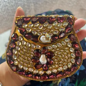 Red Kundan Clutch with Sparkling Stones and Pearl Accent for Elegant Occasions