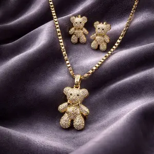 Gold Bear Necklace Set with Shimmering Gold Laminate and Sparkling Pink Gem Adorned Earrings for Playful Elegance