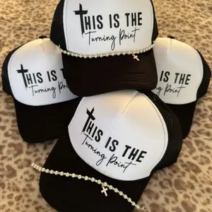 This is the Turning Point Trucker Hat with Pearl Accent and Cross Charm - Stylish and Unique Design