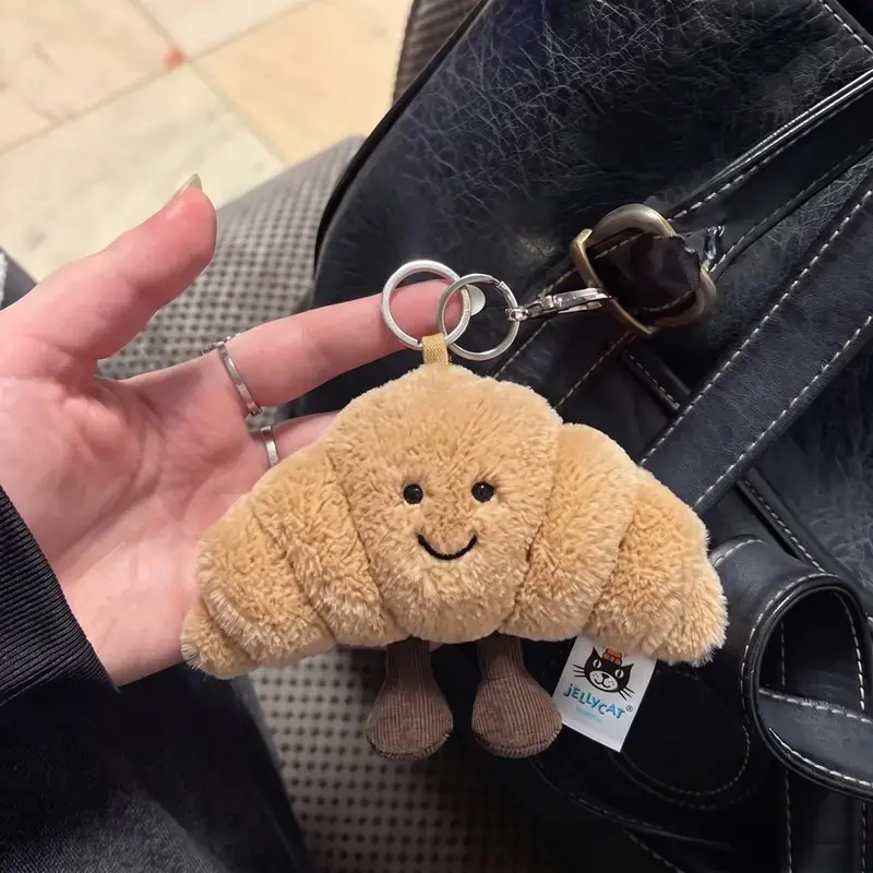Jellycat Amuseables Croissant Bag Charm – Cute Plush Croissant Keychain, Soft Kawaii Backpack Charm, Collectible Bag Accessory, Gift for Jellycat Fans & Food Lovers