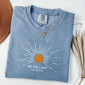Comfort Colors Be the Light Christian T-Shirt, Matthew 5:14 Scripture with Radiating Sunburst Graphic Design Faith Unisex Shirt