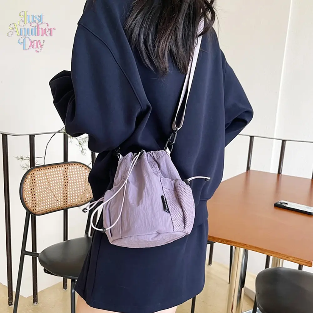 Lightweight Dusty Purple Nylon Bucket Bag Drawstring Closure with Mesh Side Pocket Mini Crossbody Sling Bag Lightweight and Water-Resistant Perfect for Daily Outings and Travel Compact and Stylish Shoulder Bag Ideal for Women on the Go