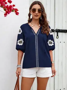 A women's solid color embroidered long-sleeved shirt with a V-neck and a loose top, suitable for summer, suitable for daily leisure seaside vacations.