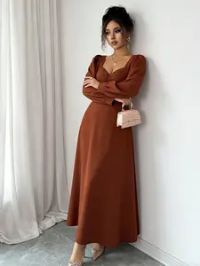 A women's caramel colored fashionable bubble sleeve waist cinching dress, with bubble sleeves adding a retro touch and French style that exudes elegance. Suitable for commuting to work, shopping and outdoor activities, indoor and outdoor dressing