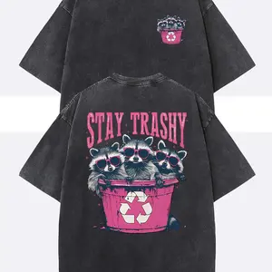 Unisex Stay Trashy Graphic Tee -  Heavyweight Washed Black Tee with Pink Raccoon & Bin Design, Relaxed Fit Crew Neck for Summer Festivals, Beach Trips & Ironic Gifts | Eco-Conscious Humor
