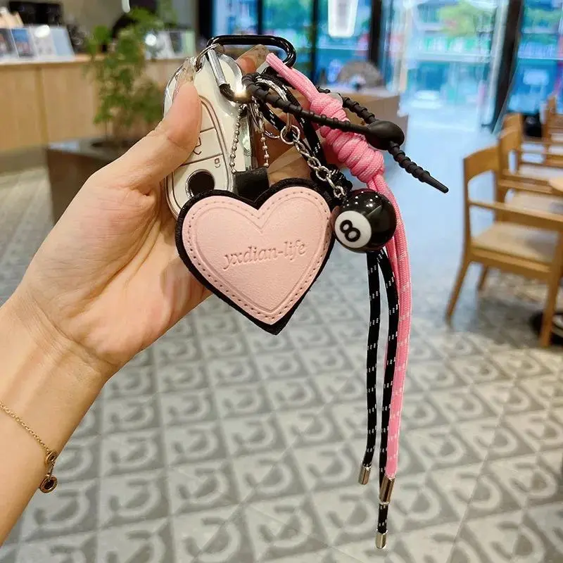Toy pendant / Toy charm Stylish and creative "Lucky Black 8" billiard ball keychain featuring a colorful woven cord—a trendy bag charm and an exquisite gift.