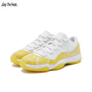 White and yellow snake print vintage low-top ball trainers pair breathable woven mesh with glossy yellow reptile leather overlays, solid yellow gum outsole, streamlined sunny silhouette is a must-have lively casual streetwear staple
