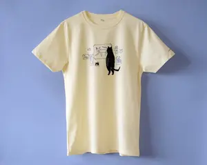 Cat gallery t-shirt | Hand screen printed on  cotton tee with black and blue illustration of a cat judging cat artCat gallery t-shirt | Hand screen printed on ecru/light yellow organic cotton tee with black and blue illustration of a cat judging cat art