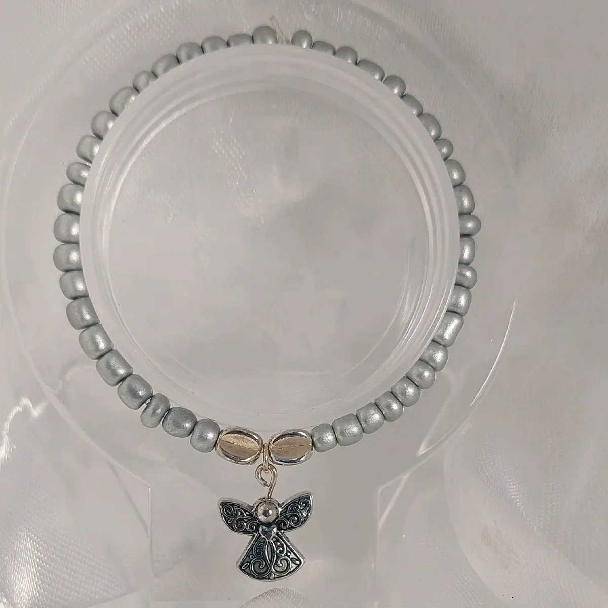 elastic silver bead bracelet with a angel charm