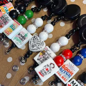 Black custom made beaded plastic Lanyards/ badge holders in several different styles and colors each with a unique focal.