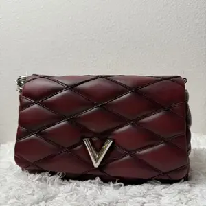Pre-owned Louis Vuitton Lambskin Clutches & Wristlets Malletage GO 14 PM bag