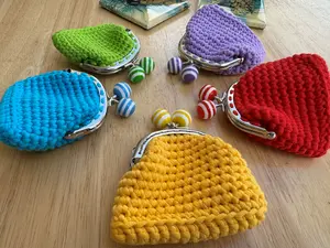 Handmade crochet wallet with a green lock buckle