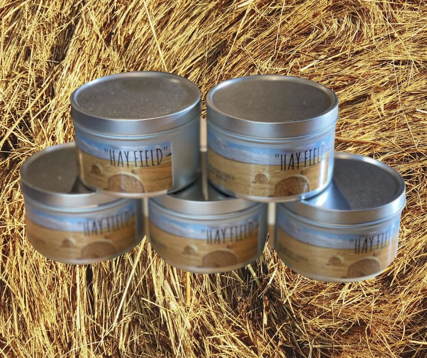 Hay Scented Candle made with 100% Soy Wax. This is a 100% handmade product by a company called Crafty American. The candle is in a 8 oz tin.