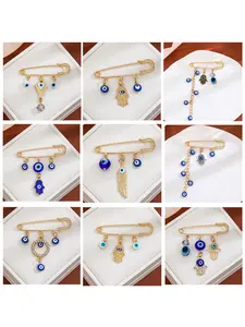European and American creative diamond-encrusted evil eye tassel brooch, a high-class blue-eye waist-cinching sweater with a cold-style pin