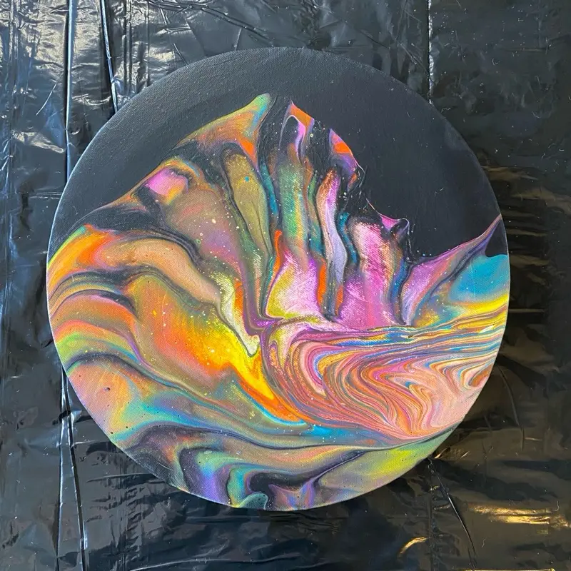 Electric Bloom Size: 10 inch round canvas Medium: Acrylic paint pouring — original, one of one