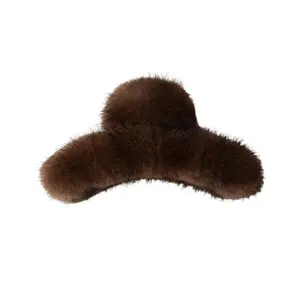Fur of mink hair creates a cute plush hairpin with an elegant appearance. The hairpin is attached to the back of the head and resembles a shark clip or a female one