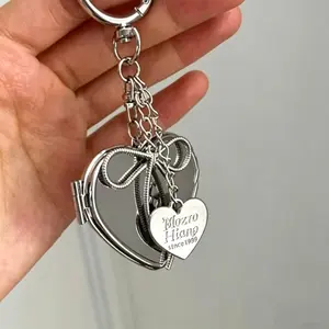 O'Case Heart Mirror Phone Charm, Premium Stainless Steel Heart Locket Keychain with Metal Bow & Engraved Tag Detachable Wrist Strap Anti-Lost Stylish Girly Y2K Luxury Silver Phone Accessory for Girls Teens Women