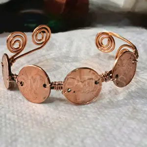 Handcrafted Copper Bracelet with Spiral Design and Coin Accents for Unique Style