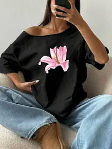 Watercolor Pink Lily Hand-Drawn Black Oversized Off-Shoulder T-Shirt | Casual Minimalist Floral Streetwear Top | Premium Cotton Fabric | Elegant Aesthetic | Relaxed Oversized Fit | Iconic Lily Print | Versatile Daily Wear | Perfect for Summer/Date/Minimal