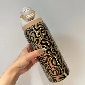 Owala 32-ounce stainless steel water bottle with golden body and black abstract pattern - equipped with a straw, suitable for sports, outdoor activities, travel and student sports water bottles.