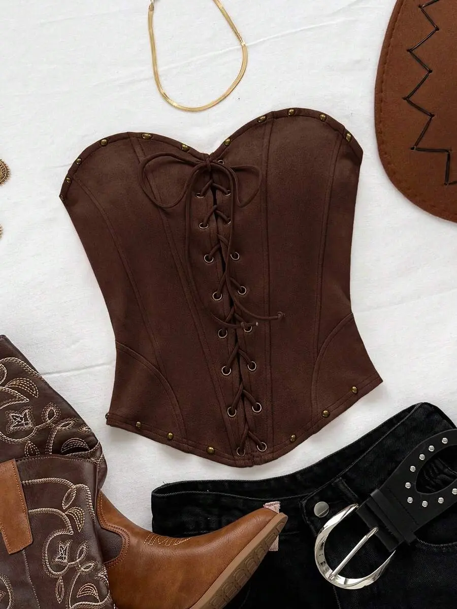 A lace and suede tube top with tie-up straps and studs, a bold design perfect for fall concerts, Bohemian-style vacations, and music festivals; no padded bra.