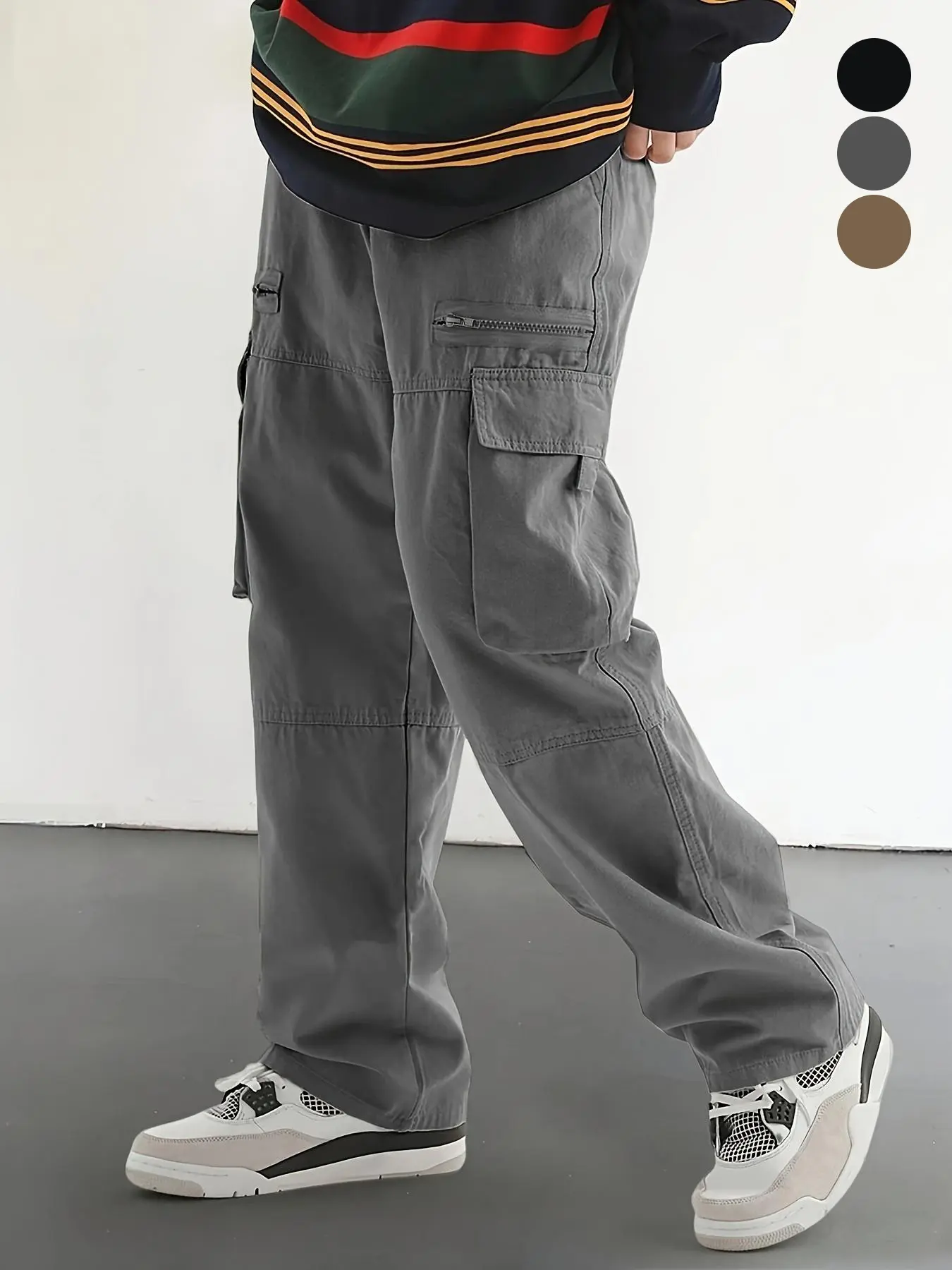 Men’s straight-leg cargo pants featuring a drawstring waist, multiple side pockets, zippered pockets paired with patch pockets, segmented panel construction, solid color with a minimalist look, a loose yet tailored fit, long pants for everyday outings, ca