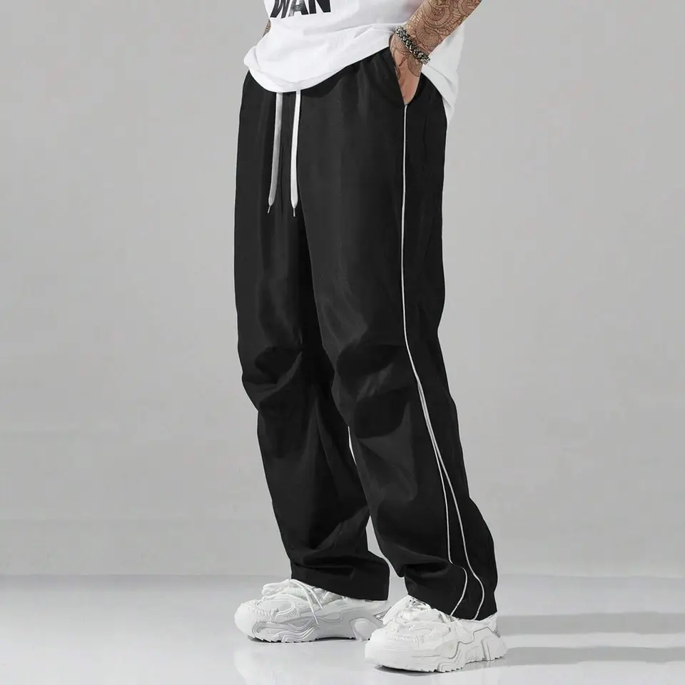 Unisex baggy wide-leg sweatpants; men’s casual athletic pants made from soft fabric with an elastic waistband and drawstring; loose fit with side stripes; breathable, lightweight sports fitness streetwear pants; all-day comfort and versatile for everyday Unisex baggy wide-leg sweatpants; men’s casual athletic pants made from soft fabric with an elastic waistband and drawstring; loose fit with side stripes; breathable, lightweight sports fitness streetwear pants; all-day comfort and versatile for everyday
