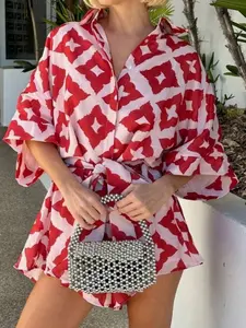 A women's shirt-style romper with red and white geometric prints and tie details, featuring bright colors and a loose fit for a trendy, casual vibe. Perfect for summer beach vacations, city street dates, or relaxed get-togethers with friends. Womenswear