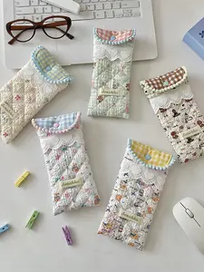 Soft and adorable quilted bag with a healing, cute pattern design. Features a fresh lace trim and soft rounded edges with delicate embellishments. A casual, minimalist, and stylish handheld bag that is versatile and easy to carry