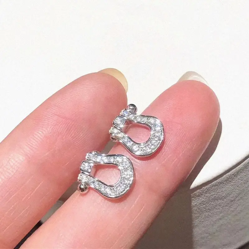 White gold horseshoe buckle earrings