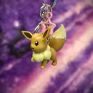 Eevee Keychain - Character Design with Unique Features, Featuring Pokeball & Wings, Perfect for Collectors and Fans