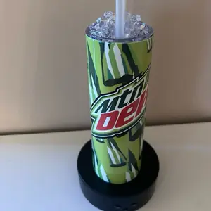 Mountain Dew Themed Tumbler with Ice and Straw, Featuring Unique Green and White Stripes, Ideal for Beverage Enthusiasts