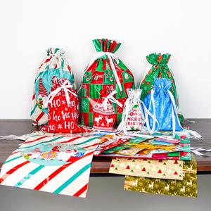 50PCS Christmas Gift Bags Christmas Wrapping Bags Including 25 gift bags and 25 labels Gift Bag & Tags Set Christmas Drawstring Gift Bags 25 Design Goody Bags Gift Bags Holiday Reusable Santa Gift Bag Assorted Sizes Extra-large Large Medium Small