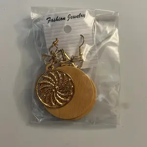 Round flat wooden earring with a metal round spin wheel costume earring
