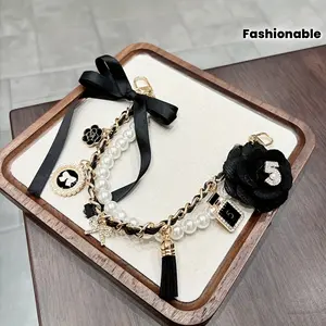 A Stylish Keychain Accessory Featuring a Creative Bow, Perfect for Enhancing Your Handbag with a Chic Camellia Decoration