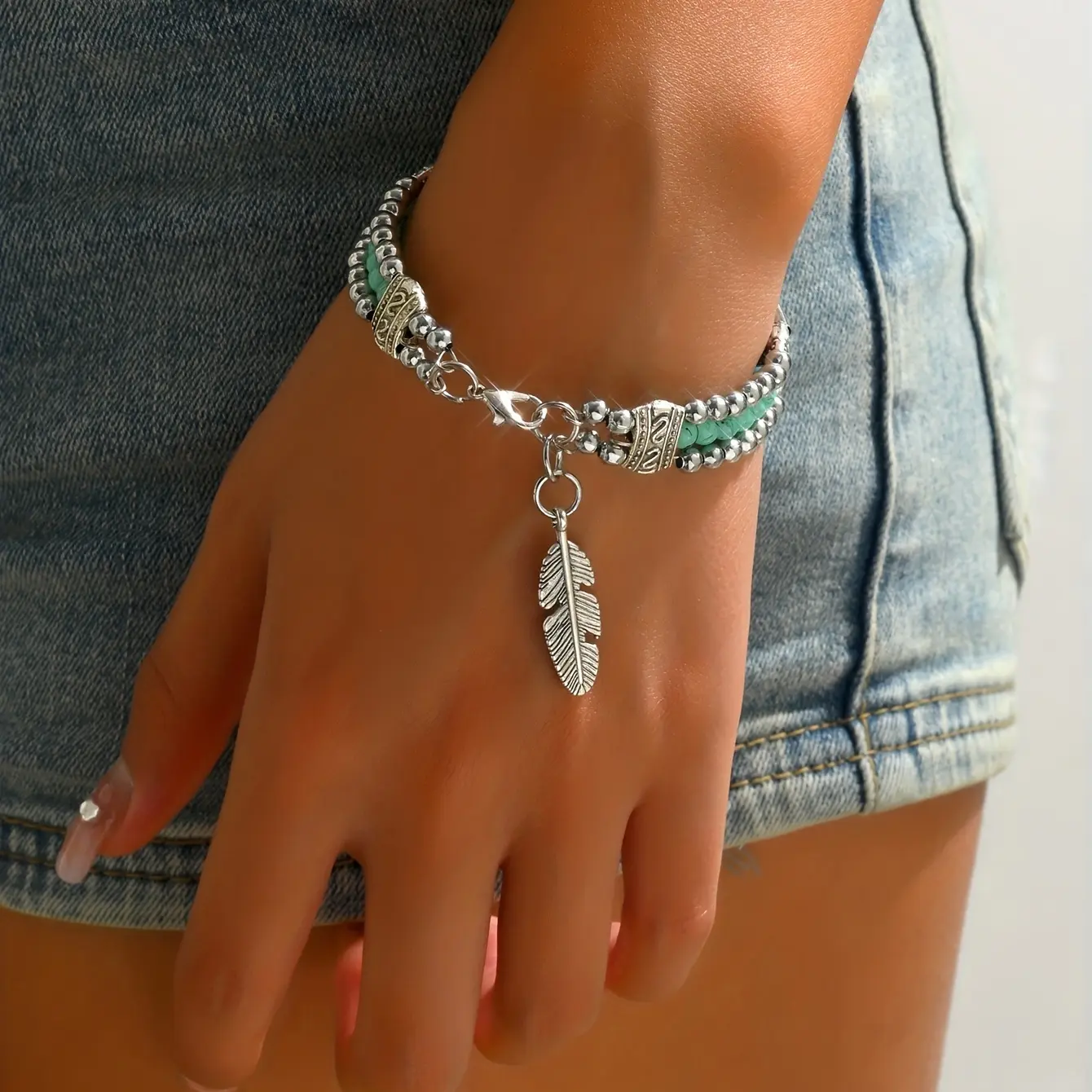 Vintage Bohemian-style bracelet, featuring two rows of turquoise beads and a delicately carved feather design
